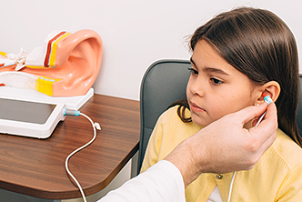 Girl taking a hearing test