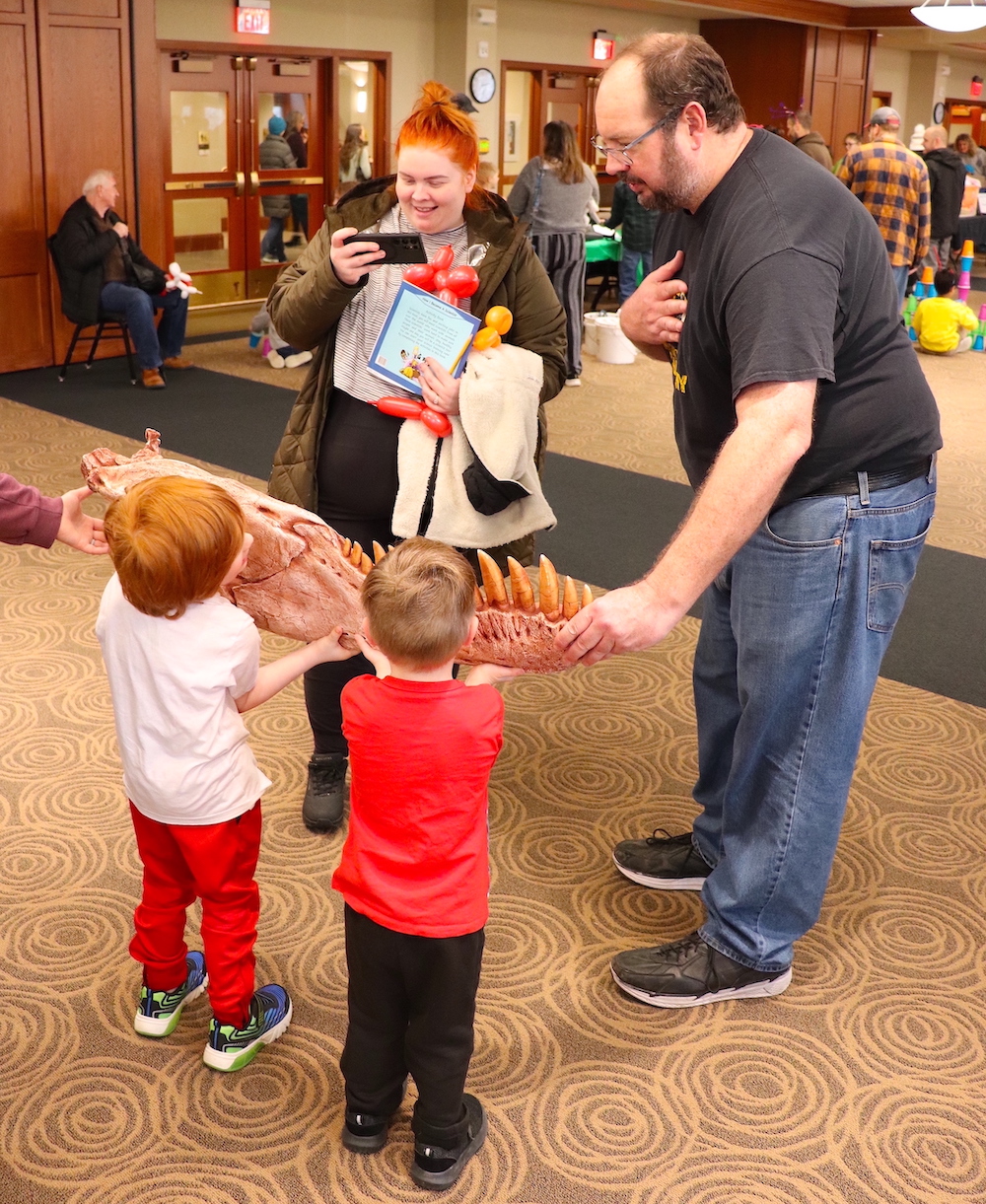 About 600 children and their parents explored University of Missouri science, technology, engineering and math research and creative activity hands-on during the Columbia Young Scientists Expo. Here, a researcher shows children the fossil of a crocodile.