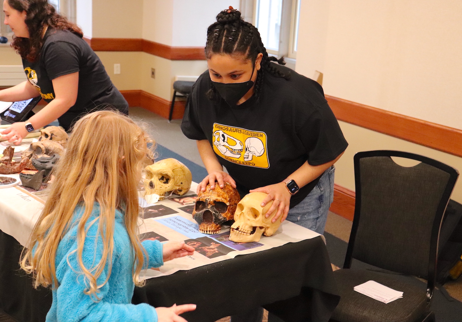 About 600 children and their parents explored University of Missouri science, technology, engineering and math research and creative activity hands-on during the Columbia Young Scientists Expo. Here, a researcher shows a child a fossilized skull.