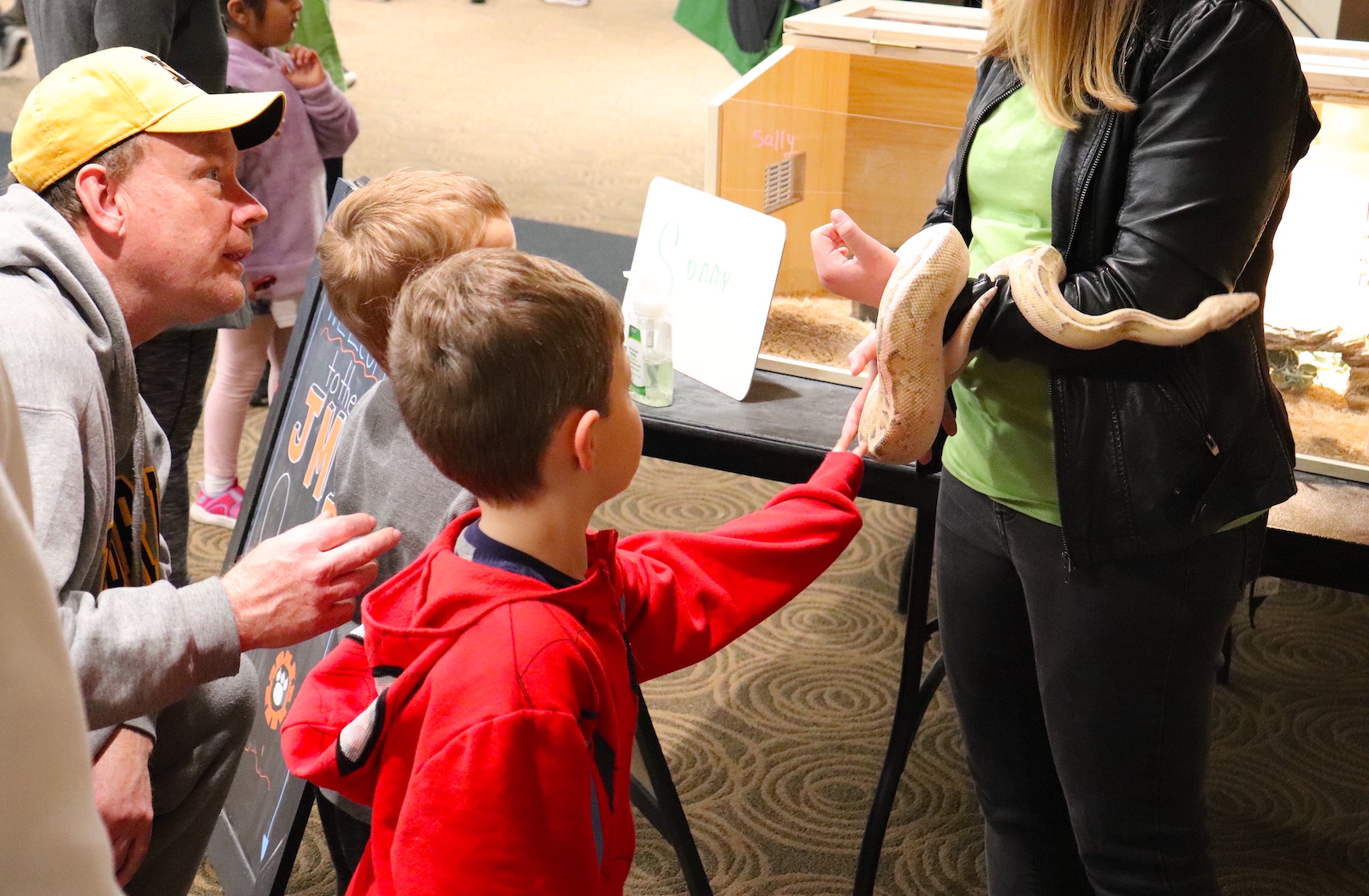 About 600 children and their parents explored University of Missouri science, technology, engineering and math research and creative activity hands-on during the Columbia Young Scientists Expo. Here, children touch a snake.