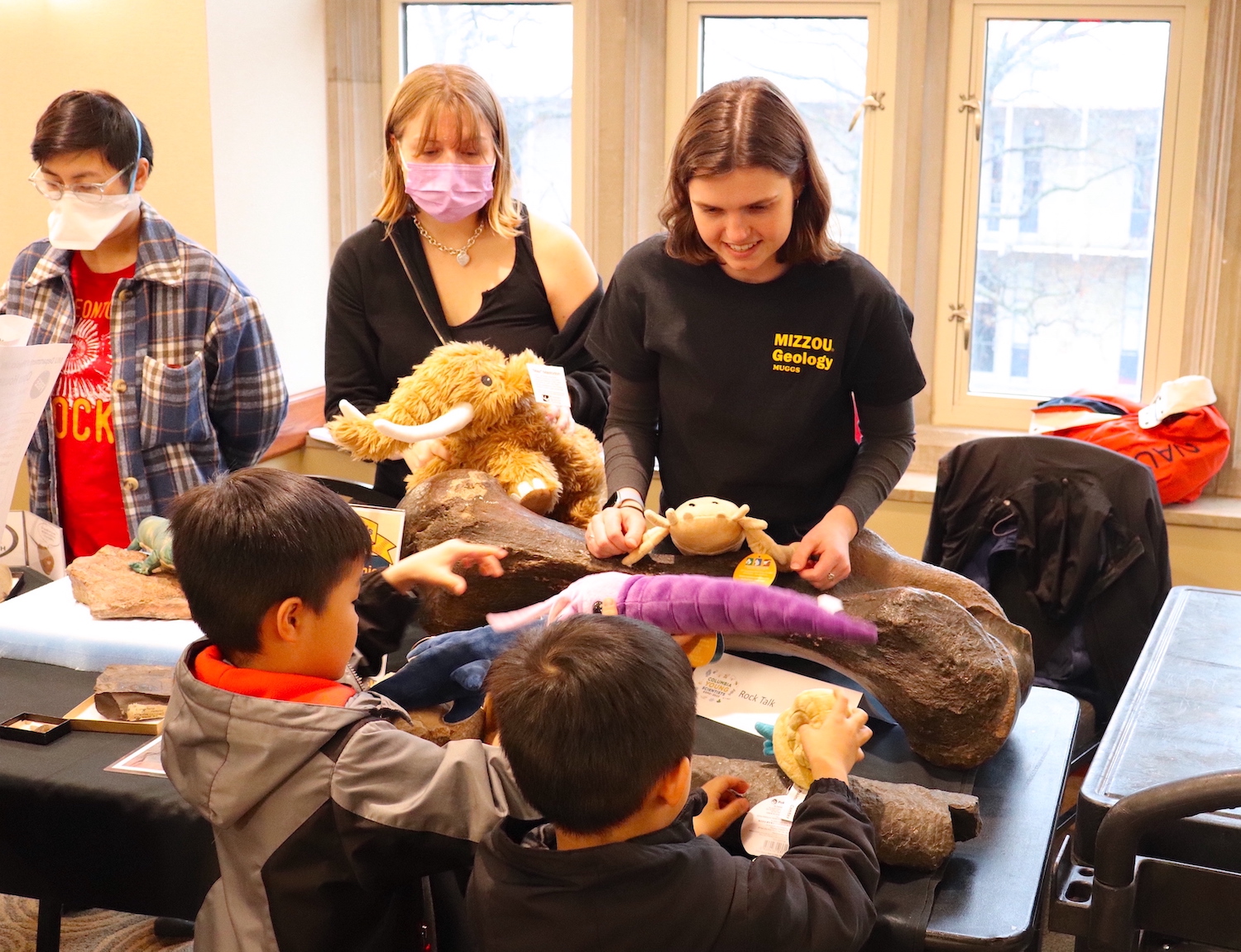 About 600 children and their parents explored University of Missouri science, technology, engineering and math research and creative activity hands-on during the Columbia Young Scientists Expo. Here, a researcher shows childen fossils.