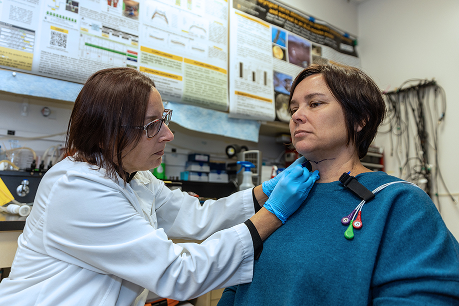 Teresa Lever, left, puts electrodes on a healthy volunteer in one of her studies.