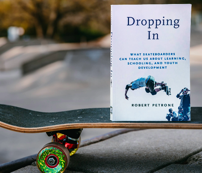 Dropping In book a top a skateboard