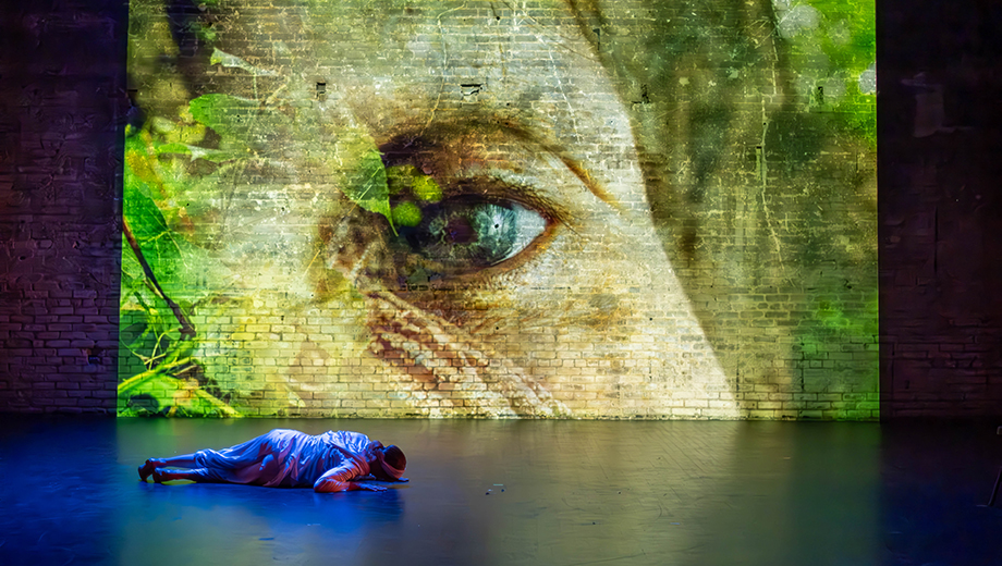 Projection of an eye with Cherie Sampson on stage during her show.