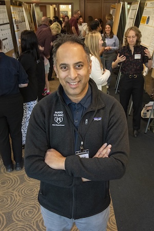 Dr. Tosh poses in front of poses at Show Me Research Week.