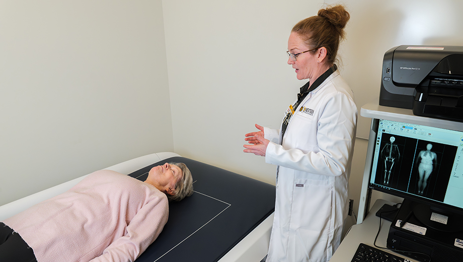 Kris Kelly, right, works with patient in CTSU study