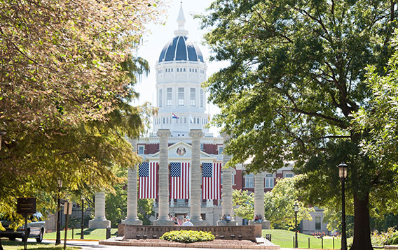 Jesse Hall at MU with three American flags