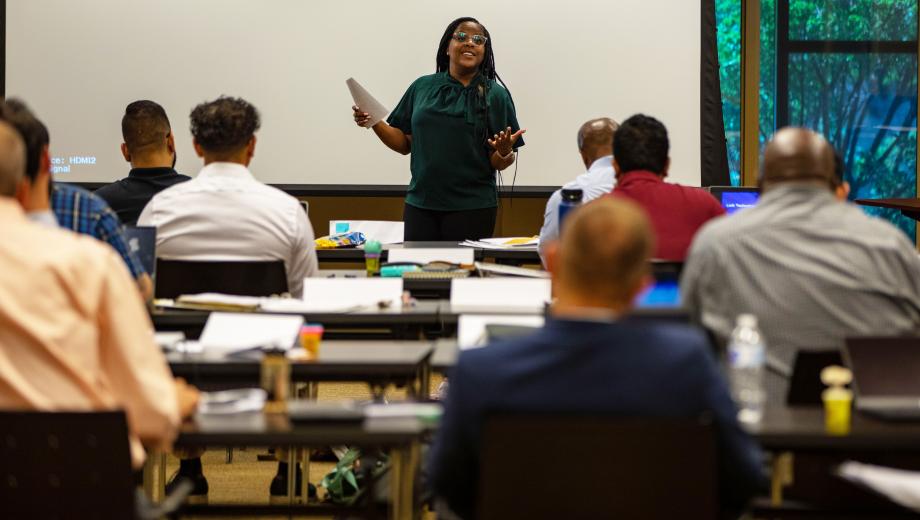 Photo of Akea Collins presenting information about her business Resume Chop Shop.