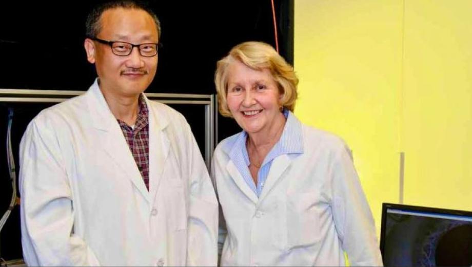 Photo of Gary Yao and Judith Miles in lab coats