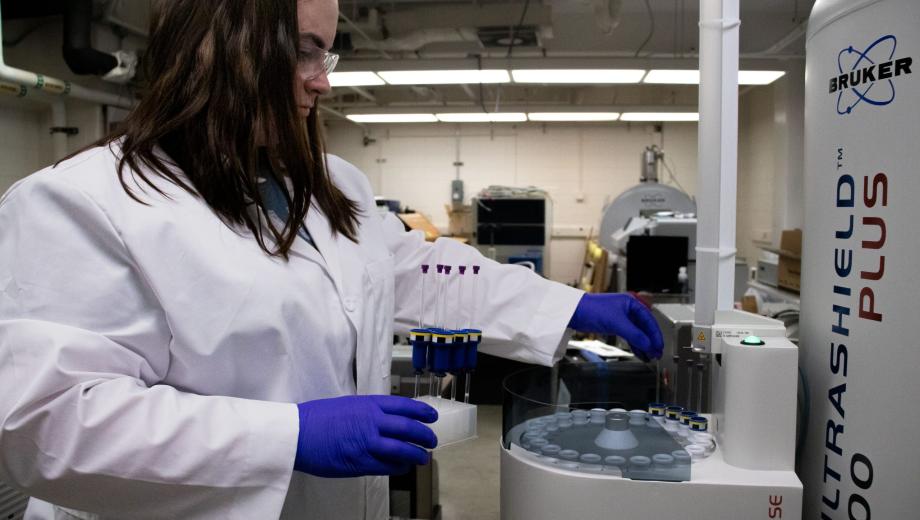 MU scientist Colleen Ray loads samples into a nuclear magnetic resonance spectroscopy machine to be tested.