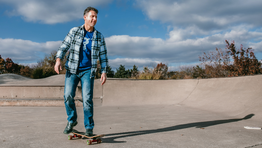 Rob Petrone rides a skateboard in the bowl of a skatepark.