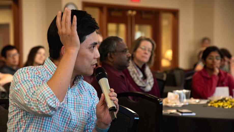 Seungmoon Lee, an assistant professor of economics, raises his hand and asks a question at the luncheon panel about NSF grant priorities during Accelerate Your Research Week 2023. 