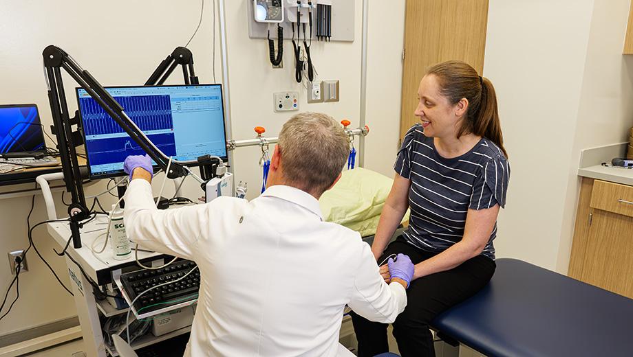 Physician Ryan Castoro with Kathryn Moss in exam room