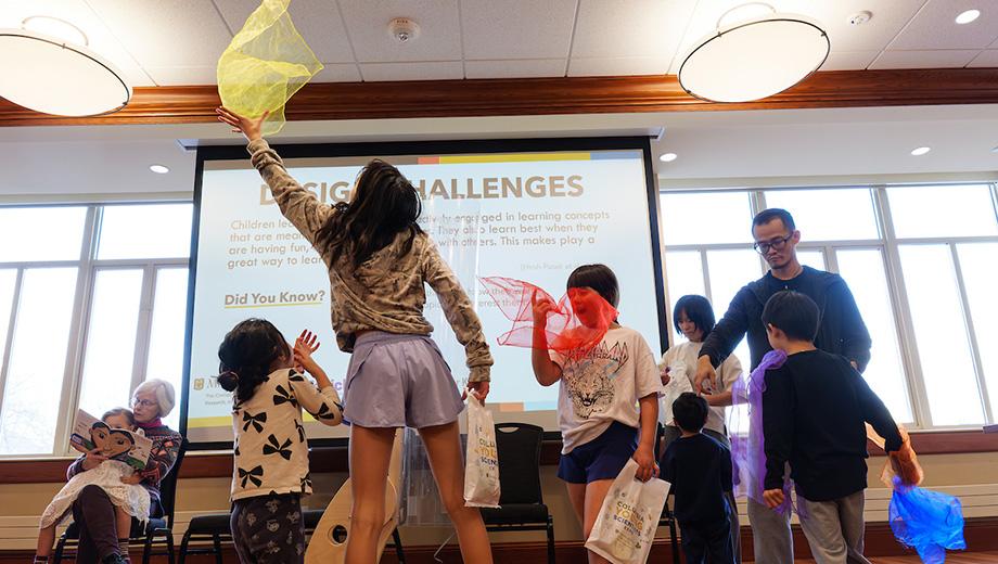 Youth catch scarves in an experiment about design solutions.