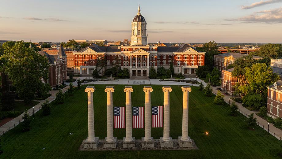 American flags hang on the Columns in front of Jesse Hall on Francis Quadrangle.