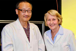 Photo of Gary Yao and Judith Miles in lab coats