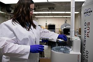 MU scientist Colleen Ray loads samples into a nuclear magnetic resonance spectroscopy machine to be tested.