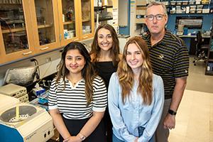 Left to right: Shift Pharmaceuticals research specialists Tanishka Kuhrani, Leah Lepore and Juliette Baker work with researcher Chris Lorson at the Bond Life Sciences Center.