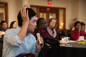 Seungmoon Lee, an assistant professor of economics, raises his hand and asks a question at the luncheon panel about NSF grant priorities during Accelerate Your Research Week 2023. 
