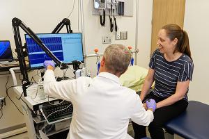 Physician Ryan Castoro with Kathryn Moss in exam room